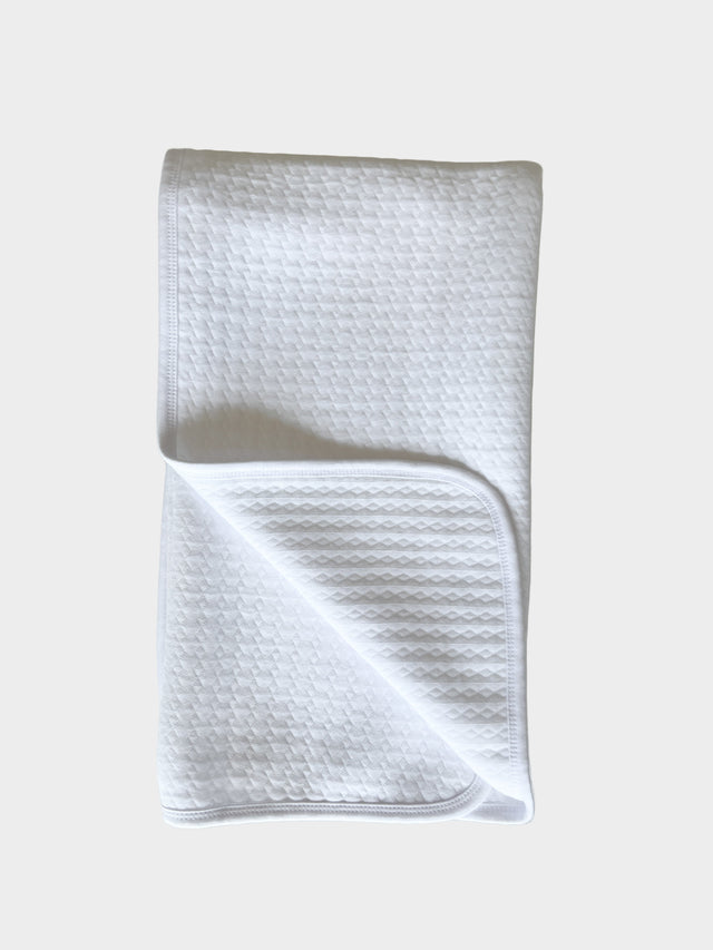 White textured towel on a light gray background