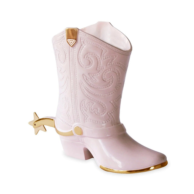 Pink cowboy boot with gold accents on a white background